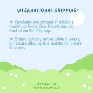 May include: A light blue graphic with the text "INTERNATIONAL SHIPPING:" and information about keychain shipping. The text is accompanied by a cartoon illustration of a white egg-shaped character. The bottom of the graphic has the website address and social media handle.