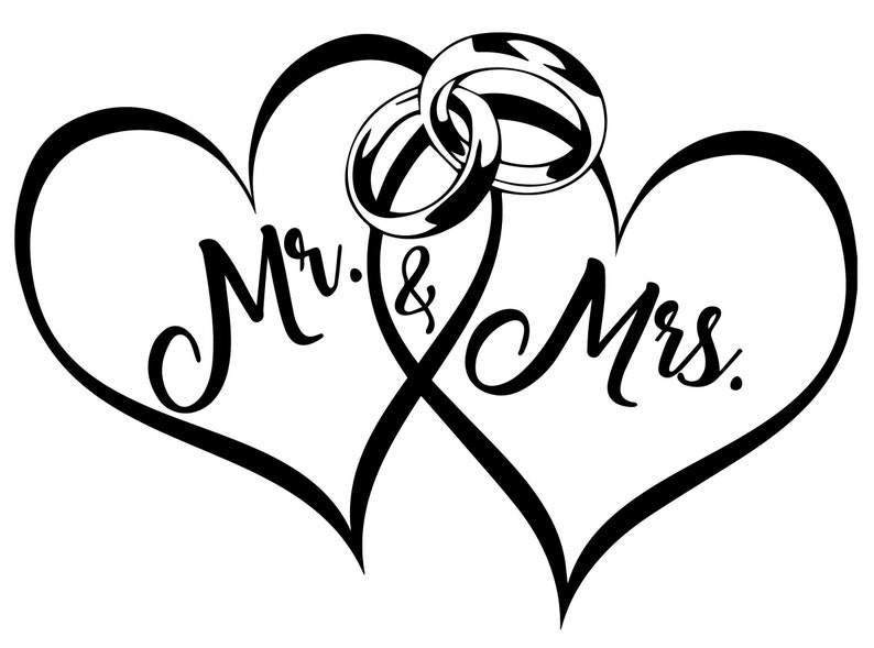 May include: Two intertwined hearts with the words "Mr. & Mrs." inside. Two gold wedding rings are placed at the top of the hearts.