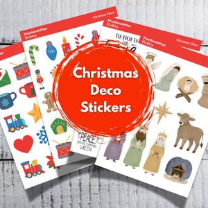 May include: Four sheets of Christmas Deco Stickers with various festive designs. The stickers include images of a train, a heart, a gingerbread man, a star, and religious figures. The text "Christmas Deco Stickers" is in a red circle.