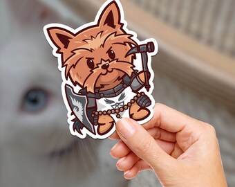 May include: A brown and white cartoon Yorkshire Terrier wearing armor, holding a hammer and a shield. The sticker is on a white background.