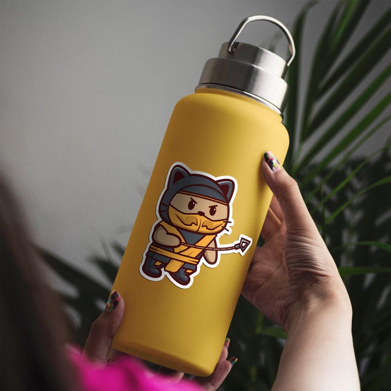 May include: A yellow insulated water bottle with a silver lid. A sticker of a cartoon ninja cat in a black and yellow outfit is on the bottle. The cat is holding a weapon. The bottle is approximately 12 inches tall.