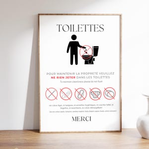 Peut inclure: Panneau encadré pour les toilettes avec le mot "TOILETTES" en haut. Un pictogramme d'une personne et des toilettes avec un symbole d'interdiction rouge. Le texte en français et en anglais conseille de ne pas jeter certains articles. Le mot "MERCI" est en bas.