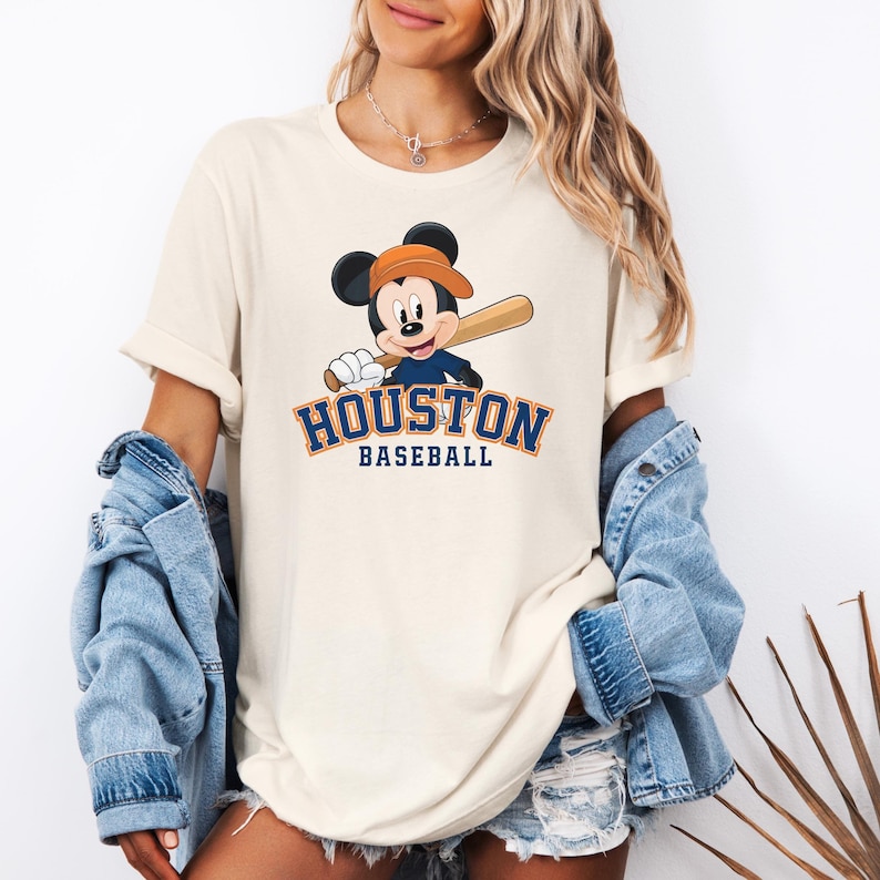 a woman wearing a houston baseball mickey mouse t - shirt