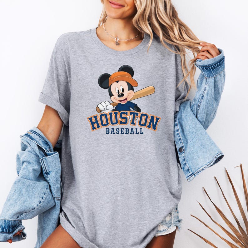 a woman wearing a mickey mouse baseball shirt