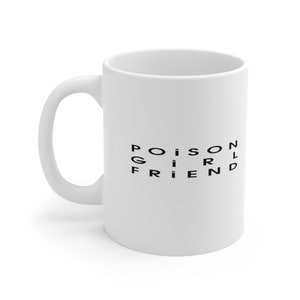 May include: White ceramic coffee mug with a black graphic that reads "POISON GIRLFRIEND".
