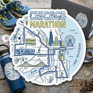 May include: A die-cut sticker featuring a map of the Chicago Marathon route. The design includes illustrations of the city skyline, a Ferris wheel, a train, the Chicago flag, and musical instruments, with the text CHICAGO MARATHON in bold letters.