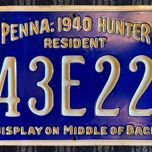 May include: Blue and white Pennsylvania 1940 Hunter Resident license plate with the number 43E22. The plate has the text "DISPLAY ON MIDDLE OF BACK" at the bottom.