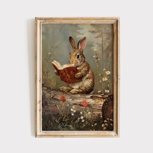 May include: A painting depicting a brown rabbit seated on a log in a woodland scene. The rabbit is holding a red book in its paws and appears to be reading. The forest is lush with green trees and flowers.