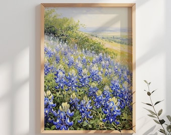 May include: A framed painting of a field of bluebonnet wildflowers in bloom. The flowers are in the foreground, with a rolling green hill and a distant view of a town in the background.