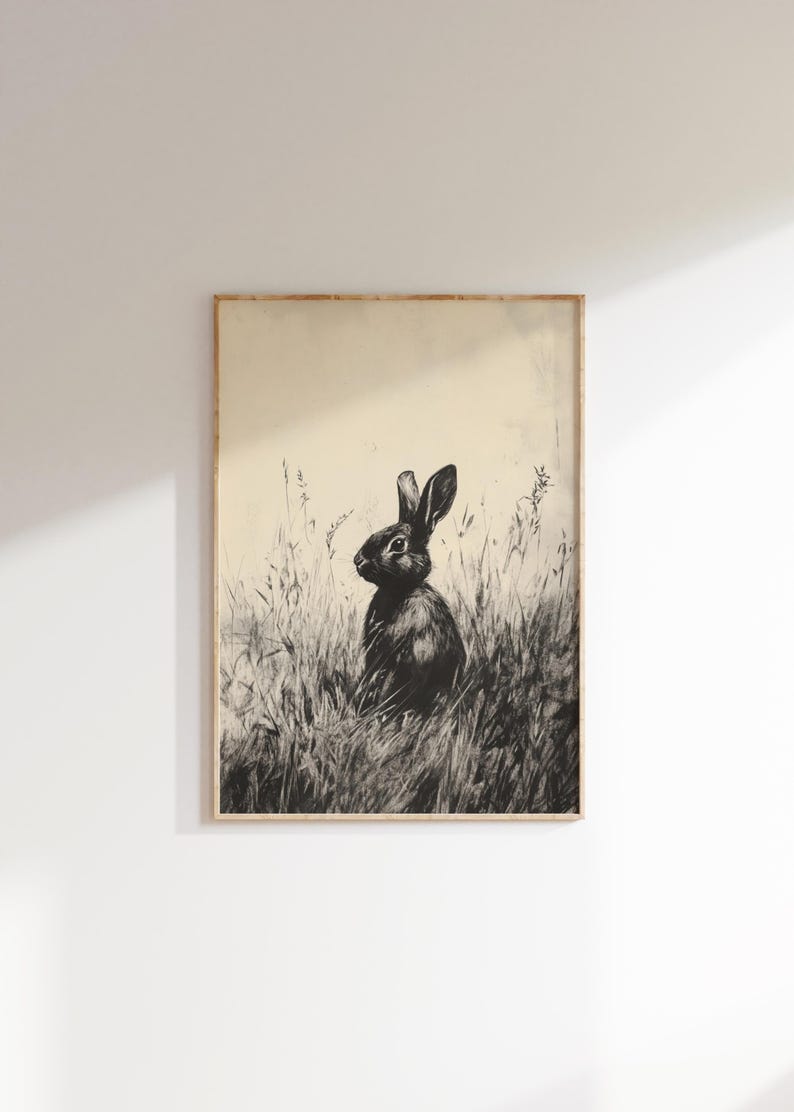 May include: A black and white illustration of a rabbit sitting in tall grass. The rabbit is looking to the right of the image.