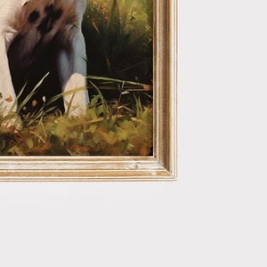 May include: A framed print featuring a dog's paws in a grassy area. The frame is a light, distressed wood with a white background. The artwork has a natural, rustic aesthetic.