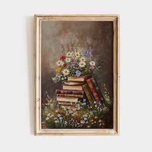 May include: A framed oil painting depicting a still life of a bouquet of wildflowers in various shades of pink, white, and yellow, arranged on top of a stack of vintage books. The flowers are surrounded by green foliage and are set against a brown background.