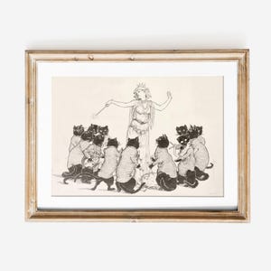 May include: A framed black and white illustration depicts a woman in a flowing gown with a crown, holding a wand, surrounded by cats. The cats are wearing sweaters and appear to be in a circle, with a light-colored background.