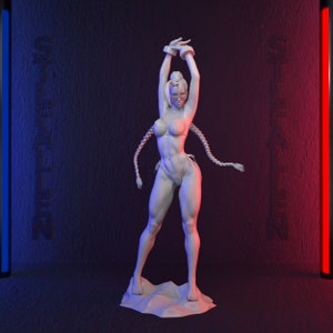 May include: A white sculpture of a female figure in a bikini, arms raised above her head. The figure has long braids and is standing on a textured base. The background is dark with vertical blue and red light bars and the word "STEALIN" in the background.