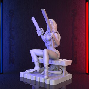 May include: A 3D-printed figurine of a woman holding a chainsaw and a double-barreled shotgun. She is seated on a wooden bench, with a person kneeling beneath it. The figure is in a light color, with a dark background.
