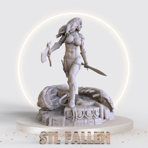 May include: A grey 3D printed figurine of a female warrior standing on a base with a dragon design. The warrior is holding a sword and an axe. The base is inscribed with the text "STL FALLEN".