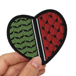 May include: A black heart-shaped patch with a green and red design. The left side of the heart is green with a textured pattern, and the right side is red with a honeycomb pattern.