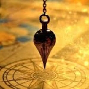 May include: A dark, teardrop-shaped pendulum suspended above a compass rose design. The pendulum is attached to a chain and hangs over a map with gold and brown tones. The image has a mystical, exploratory theme.
