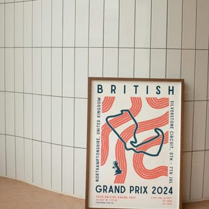 May include: A framed poster with a white background and a blue and red illustration of the Silverstone Circuit race track. The poster is titled "British Grand Prix 2024" and includes the location, date, and race details.