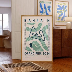 May include: A poster with a minimalist design featuring a stylized map of the Bahrain International Circuit in green and blue. The poster has the text "Bahrain" in a bold font and "Umm Jadid, Sakhir, Bahrain" in a smaller font. The poster also includes the text "Bahrain International Circuit, 29th - 2nd Mar" and "Grand Prix 2024".