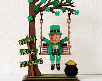 May include: A wooden St. Patrick's Day decoration featuring a leprechaun on a swing, a tree with shamrocks, and a pot of gold. The sign reads "Lucky Irish St. Patrick". The leprechaun wears a green suit and hat.