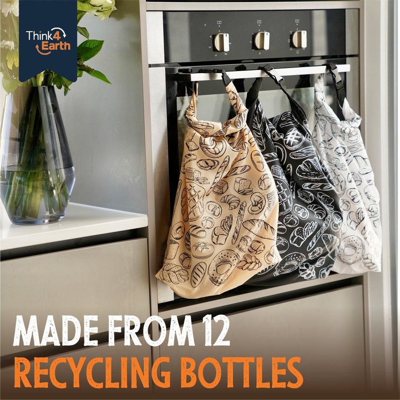 May include: Three reusable shopping bags hanging on a rack. The bags are made from recycled plastic bottles and feature a pattern of various bread and pastry items. The text "MADE FROM 12 RECYCLING BOTTLES" is printed on the bottom of the image.