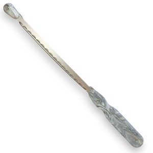 May include: A bread knife with a serrated stainless steel blade and a marbled gray and white handle. The knife is designed for slicing bread and other baked goods. The total length of the knife is approximately 15 inches.