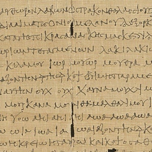 May include: A section of ancient papyrus featuring handwritten text in black ink. The papyrus has a light brown hue, with vertical tears and imperfections. The text appears to be in Greek.