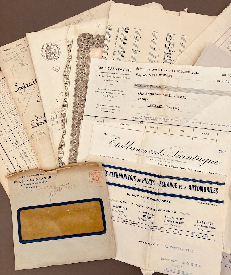 May include: A vintage envelope with a blue and white stamp that says "40". The envelope is addressed to "Monsieur MOREL Garage MAINBAT" and dated "12 F&eacute;vrier 1935".