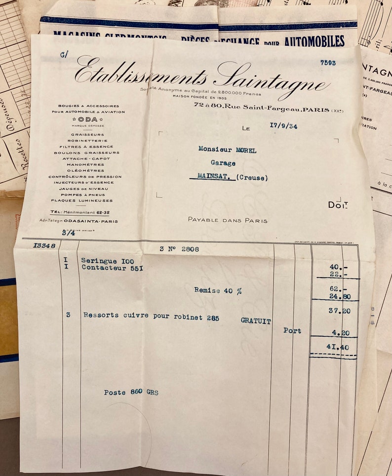 May include: A vintage invoice from Etablissements Saintagne, a French automotive parts company, dated September 17, 1934. The invoice is for a syringe, a contactor, and springs for a faucet. The total cost is 41.40 francs.