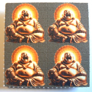May include: Four images of a laughing Buddha, each with a halo of light, sitting in a meditative pose with hands in their lap. The background is a gray, textured surface.