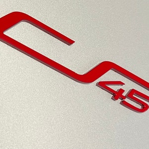 May include: Red 45 logo on a silver background. The logo is a stylized number 45 with a curved line above it.
