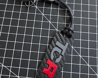 Keyring in carbon look with painted TCR logo.