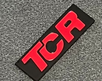 VW Golf GTI TCR emblem, logo for radiator grille. Color: Piano Black / Tornado Red
