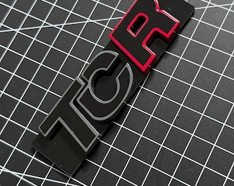 Golf 7 GTI, TCR, radiator grille emblem. Custom-made in black / Pure Grey / Tornado Red
