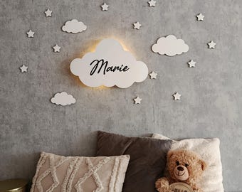 Cloud-shaped LED wall lamp with personalization for children's room decor.