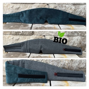 May include: Three sleep masks in shades of teal and gray, each with a curved design to fit the face. The masks have a Velcro strap for adjustable sizing. The word "BIO" is printed on one of the masks.