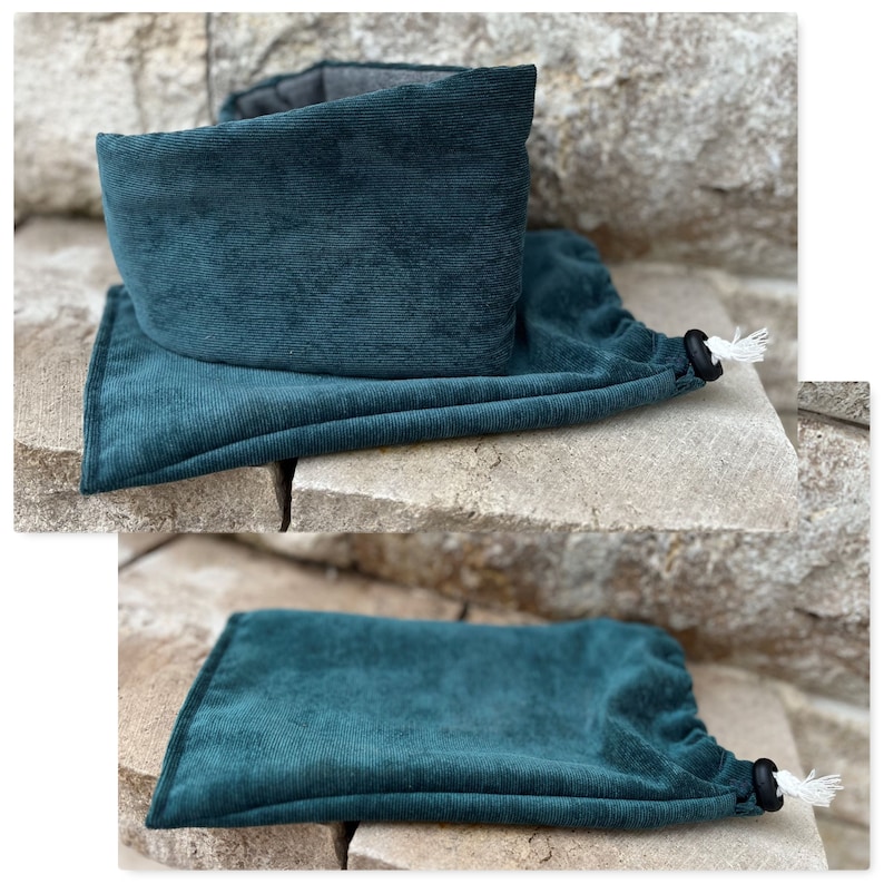 May include: Teal corduroy neck warmer and matching drawstring bag. The neck warmer is folded over, revealing a gray interior. The drawstring bag is closed with a black toggle and white cord. The items are displayed on a stone surface.