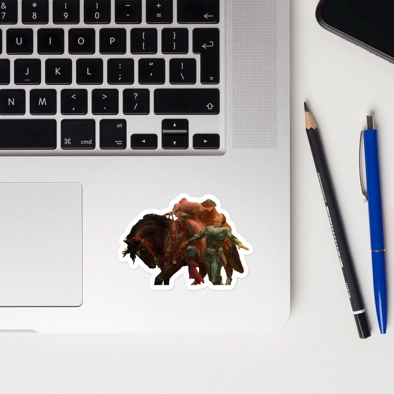 May include: A sticker featuring a fantasy scene of a dark brown horse with riders. The riders are depicted in shades of red and green. The sticker is placed on a laptop.