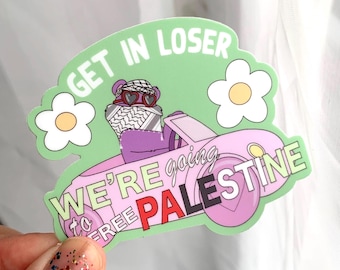 May include: A sticker with a green background and the text "GET IN LOSER". It features a pink car with the text "WE'RE going to FREE PALESTINE". A bear wearing heart-shaped sunglasses and a keffiyeh is driving the car.