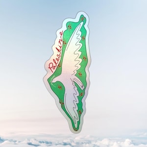 May include: A sticker featuring a white dove carrying an olive branch, set against a green backdrop with floral accents. The word "Palestine" is written in red script. The sticker has a holographic finish.