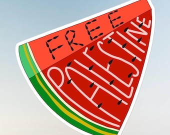 May include: A watermelon slice sticker with the words "FREE PALESTINE". The red fruit has black seeds, white lettering, and a green and yellow rind. The background is light blue.