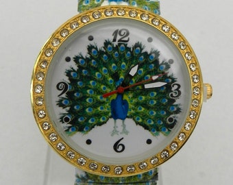 Damen Armbanduhr, Pfauenmotiv, Kristalle, elastik Armband - Neu