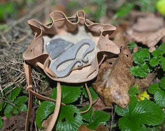 Firesteel and flint in a leather pouch. For bushcraft and survival.