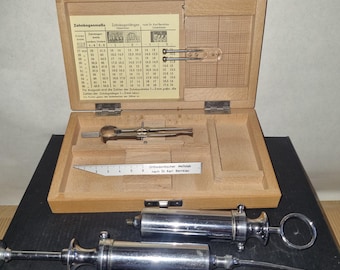 Accesorios para dentistas y técnicos dentales: jeringas, caja de herramientas de madera con medidores de arco dental.