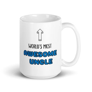 May include: White ceramic coffee mug with a black arrow pointing upwards and the text "World's Most Awesome Uncle" in blue lettering.