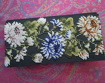 The clutch is embroidered with beads