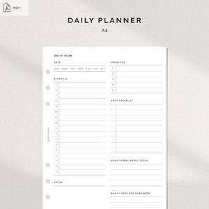 May include: A black and white printable daily planner with sections for daily plan, priorities, schedule, daily checklist, good things about today, notes, and what I hope for tomorrow. The planner is labeled "Daily Planner" and "A5".