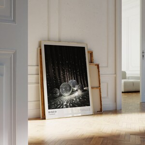 May include: A framed poster with a black background and a group of silver disco balls reflecting light. The poster has the word "DISCO" in white text at the bottom.