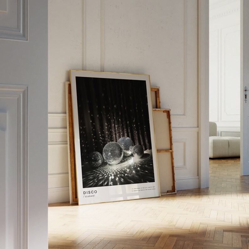 May include: A framed poster with a black background and a group of silver disco balls reflecting light. The poster has the word "DISCO" in white text at the bottom.